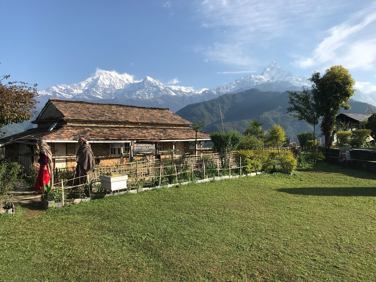 The Annapurna Eco-Village sign and villagers
